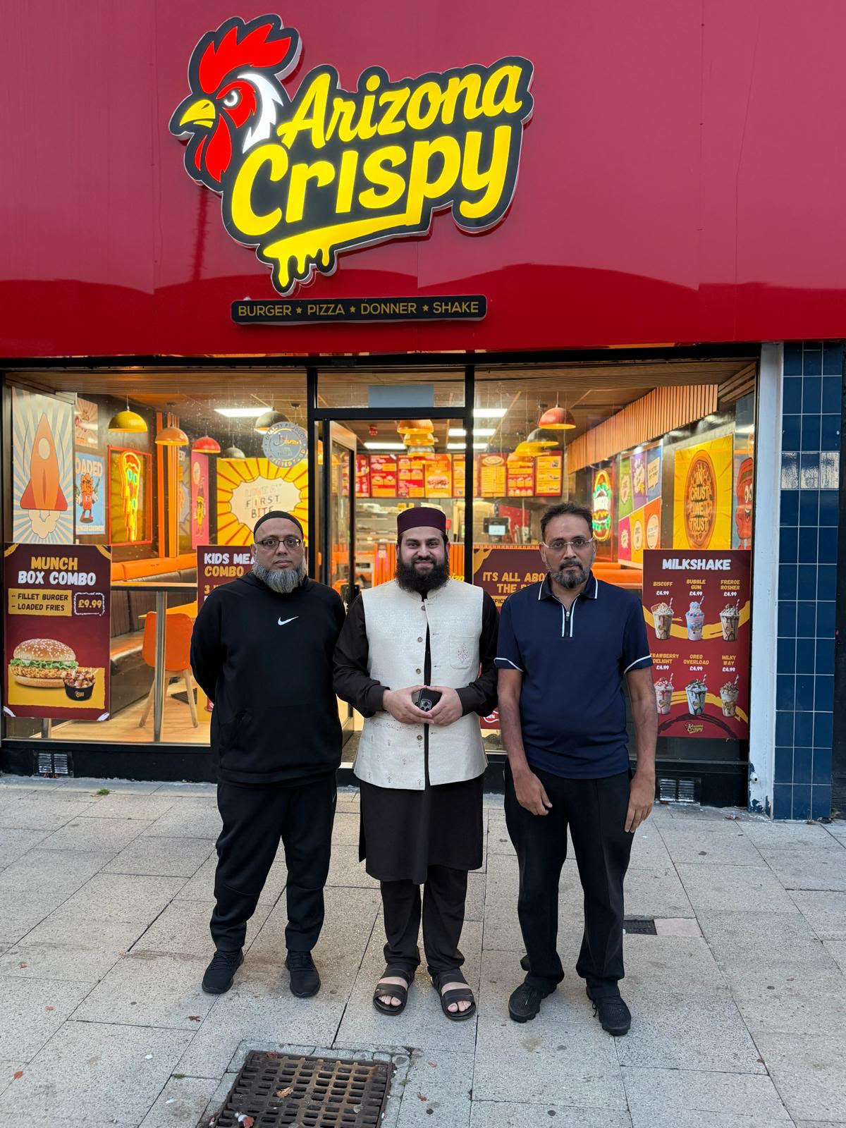 Hafiz Ahmed Raza Qadri and guests outside the Arizona Crispy storefront in Bury
